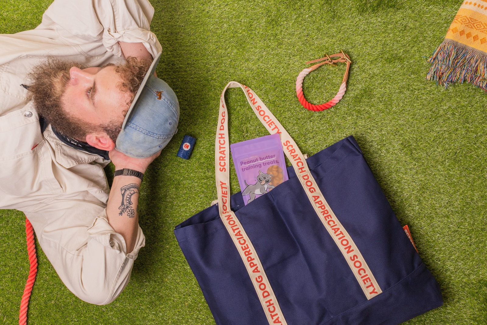 Man laying on ground with tote bag